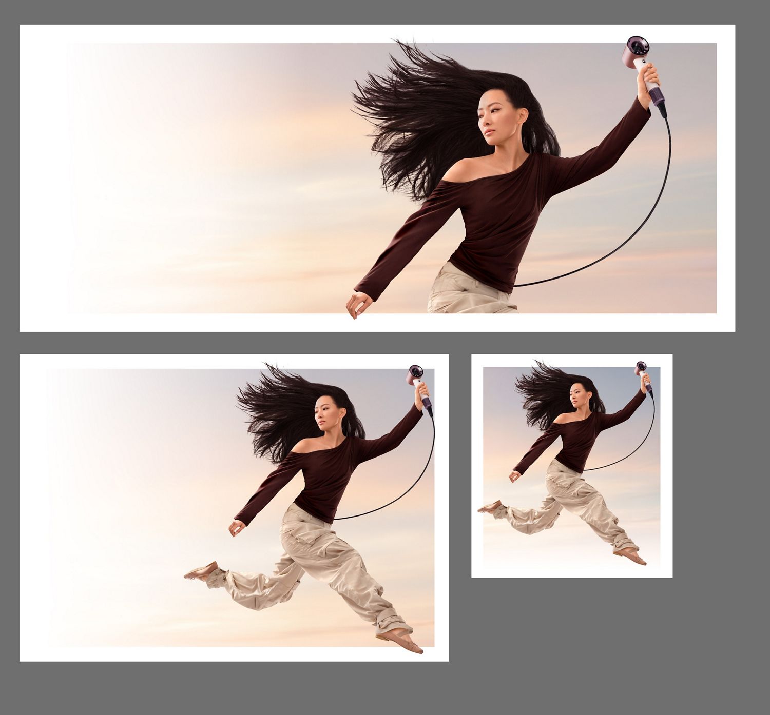 A jumping model in mid-air holding the Dyson Supersonic Travel hair dryer.