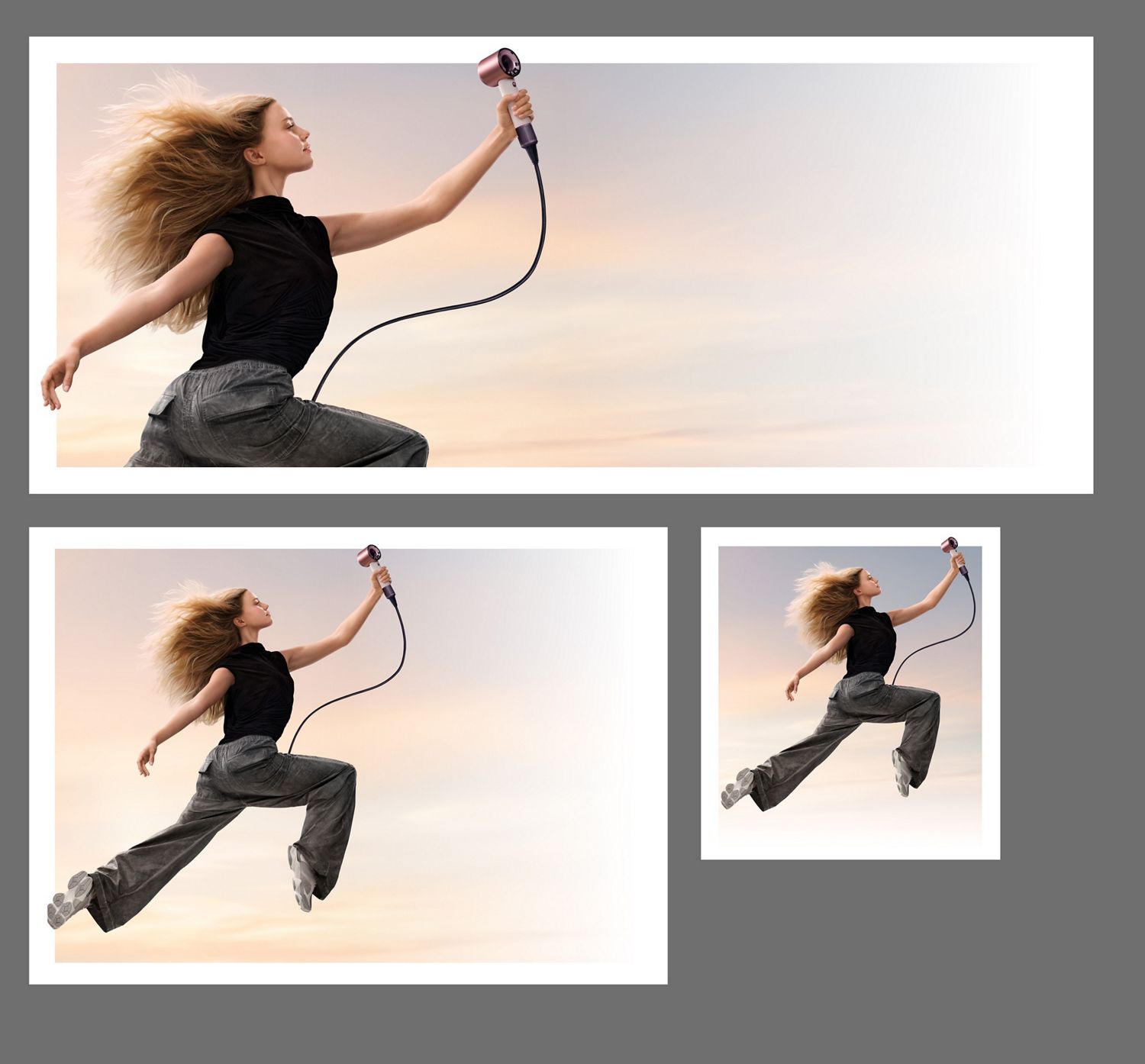 A jumping female model in mid-air holding the Dyson Supersonic Travel hair dryer.