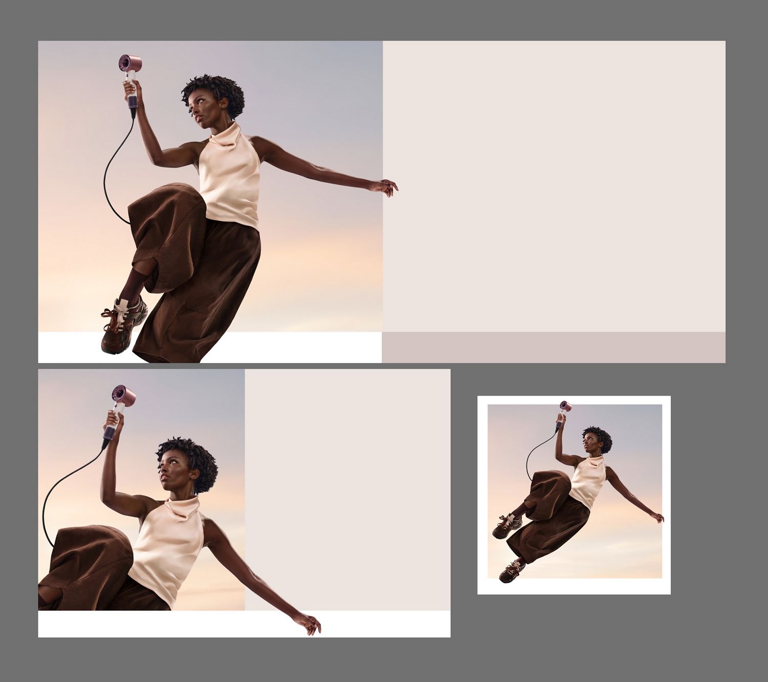 A jumping female model with curly coily hair in mid-air holding the Dyson Supersonic Travel hair dryer.