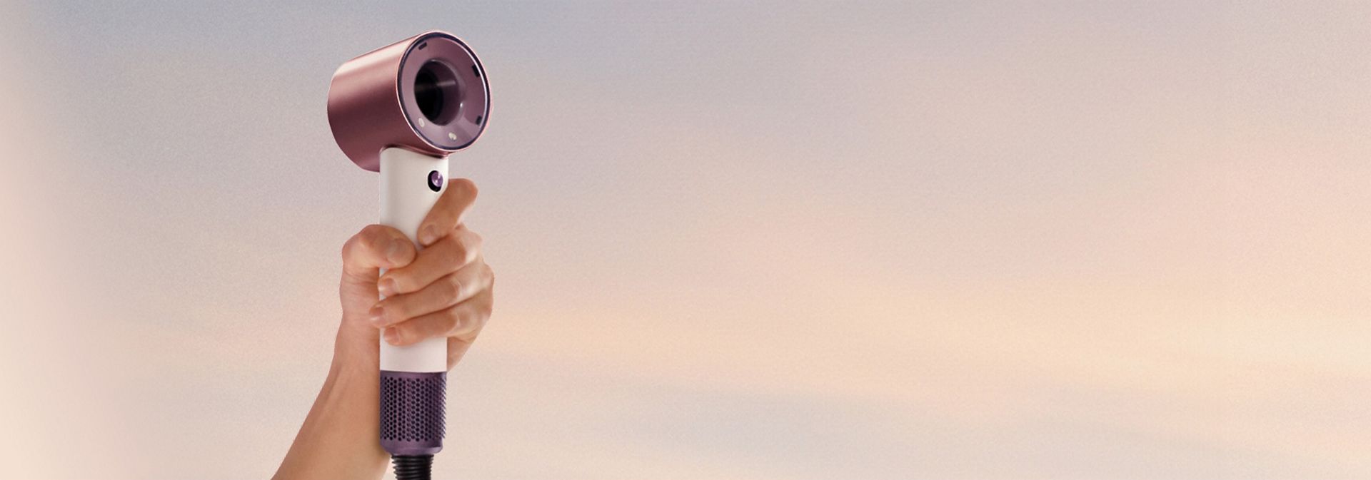 Dyson Supersonic Travel hair dryer held in a hand.