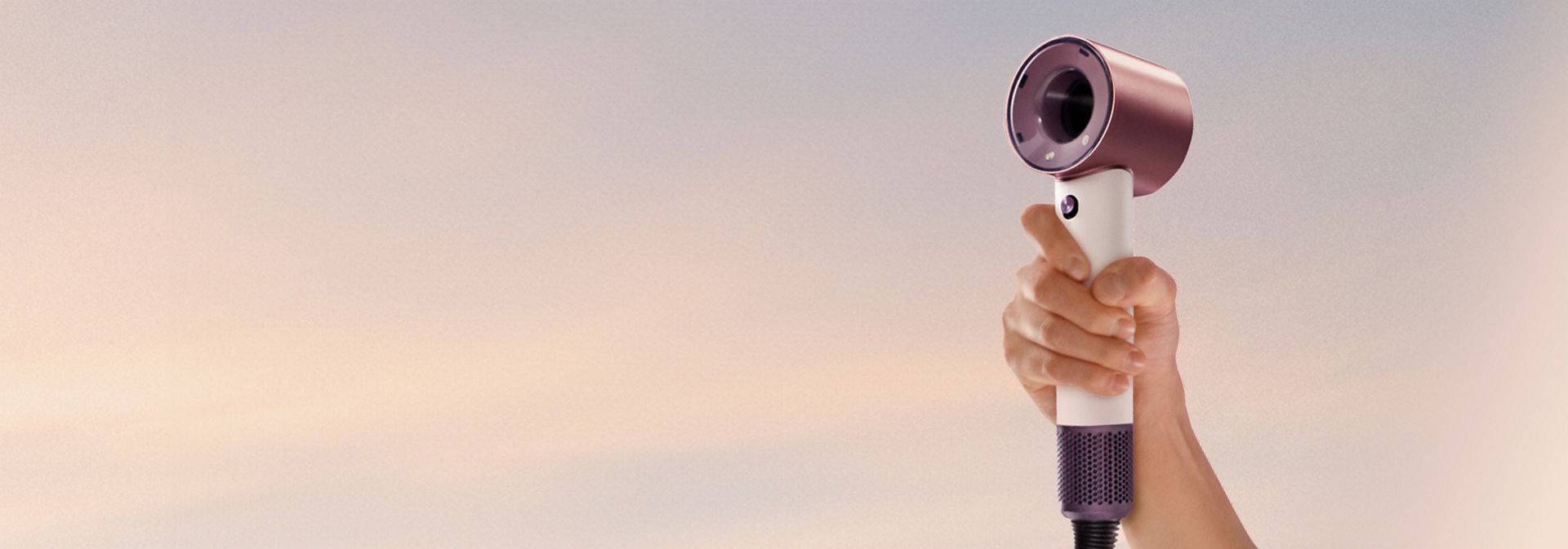 Dyson Supersonic Travel hair dryer held in a hand.