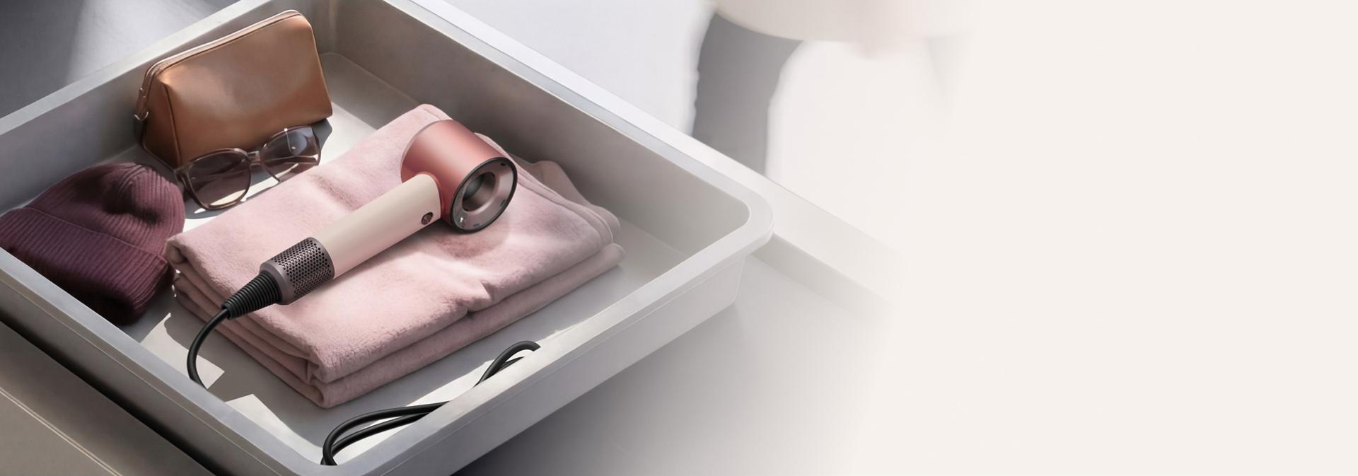 Dyson Supersonic Travel hair dryer in an Airport luggage screening tray.