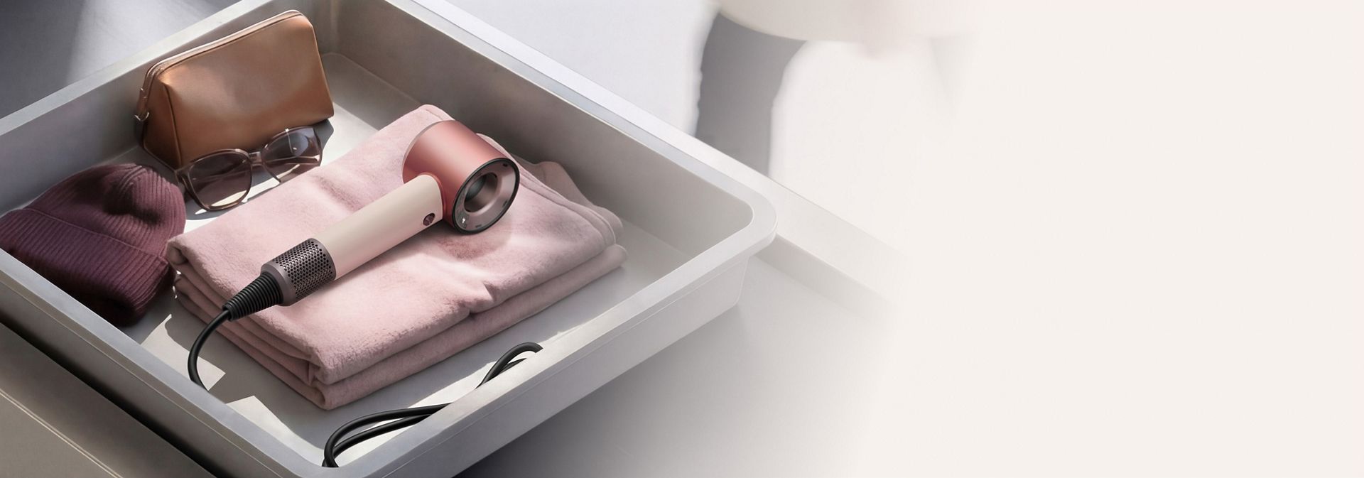 Dyson Supersonic Travel hair dryer in an Airport luggage screening tray.