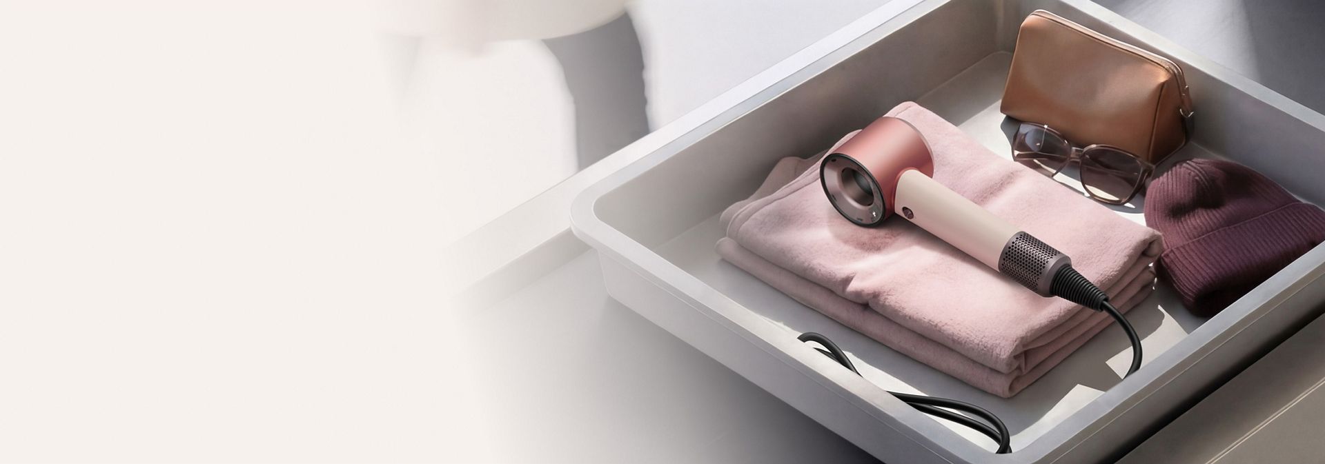 Dyson Supersonic Travel hair dryer in an Airport luggage screening tray.