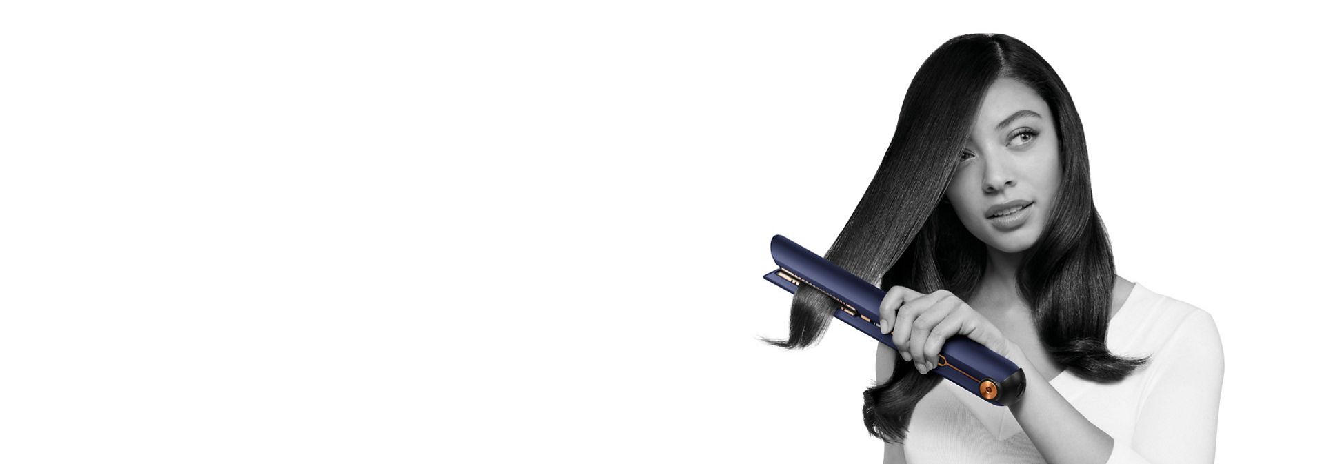 Model straightens her hair with the Dyson Corrale straightener.