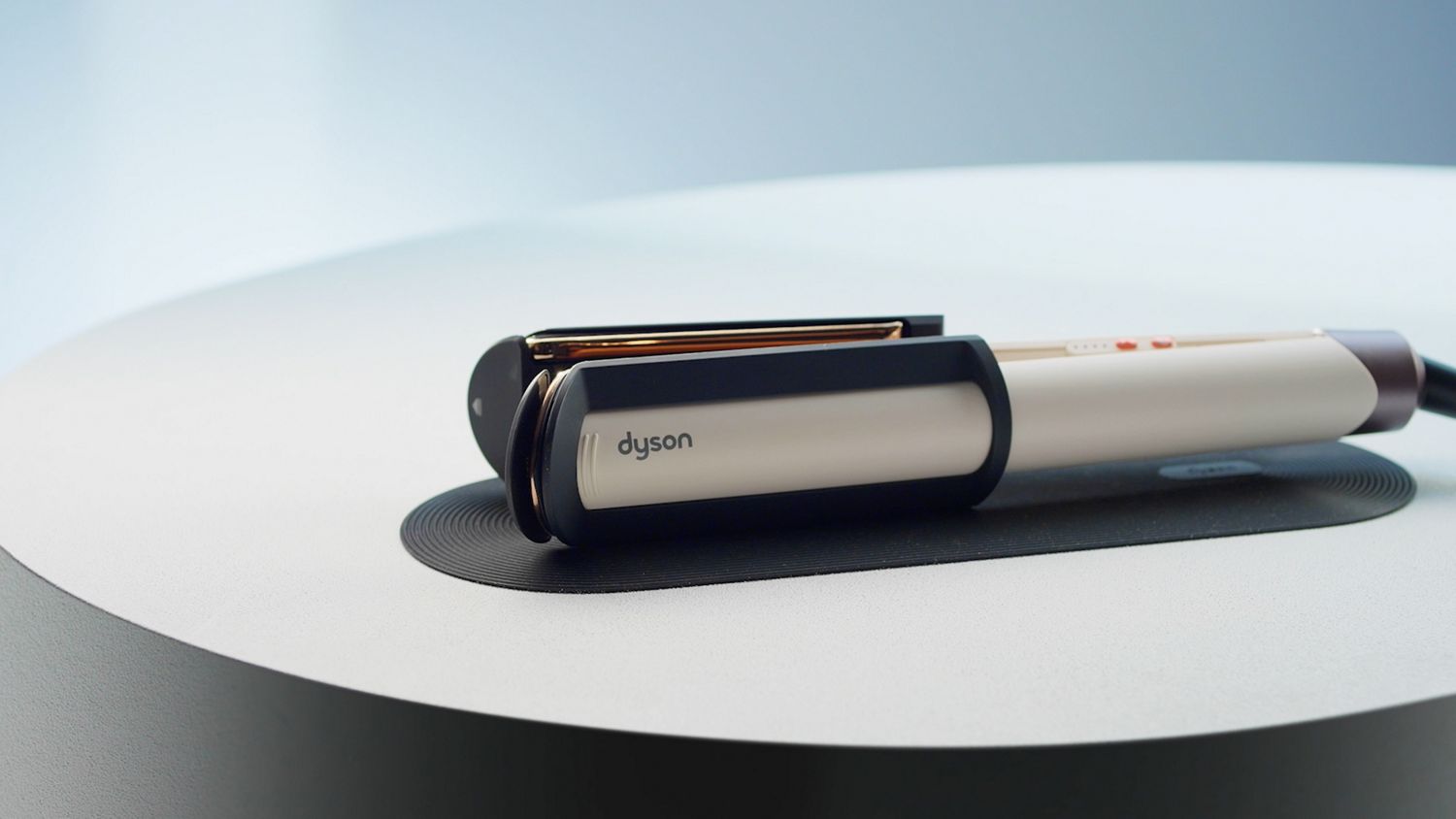 Dyson Corrale CoolShine hair straightener placed on the non-slip heat mat.