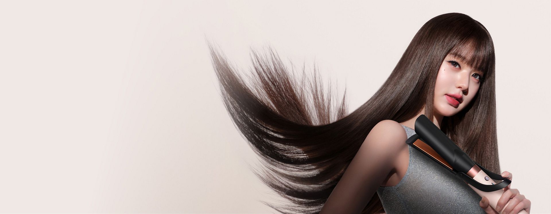 Jang Won-young straightens her hair with the Dyson Airwrap Co-anda2x multi-styler and dryer.