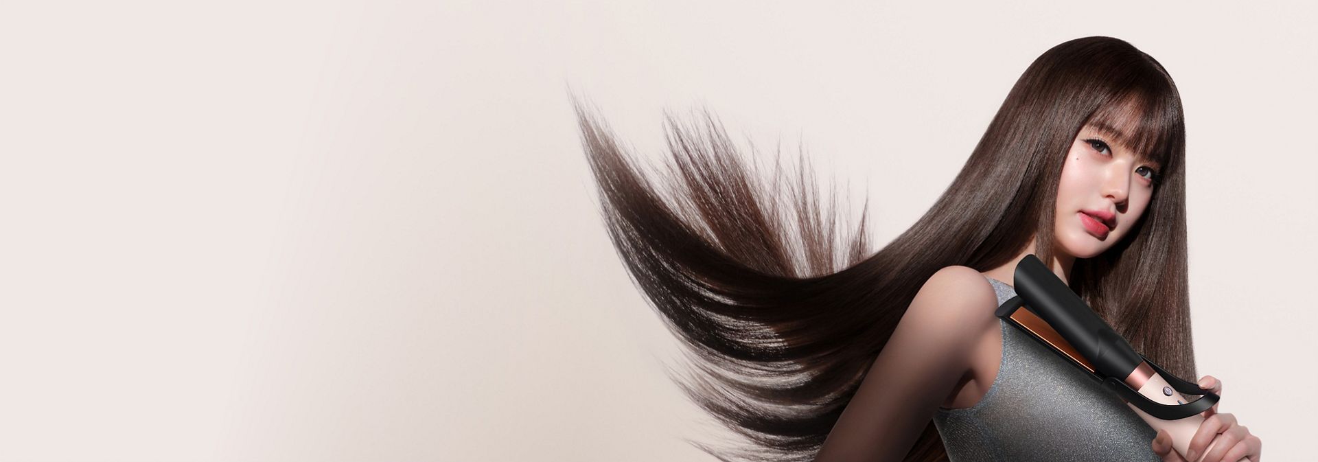 Jang Won-young straightens her hair with the Dyson Airwrap Co-anda2x multi-styler and dryer.