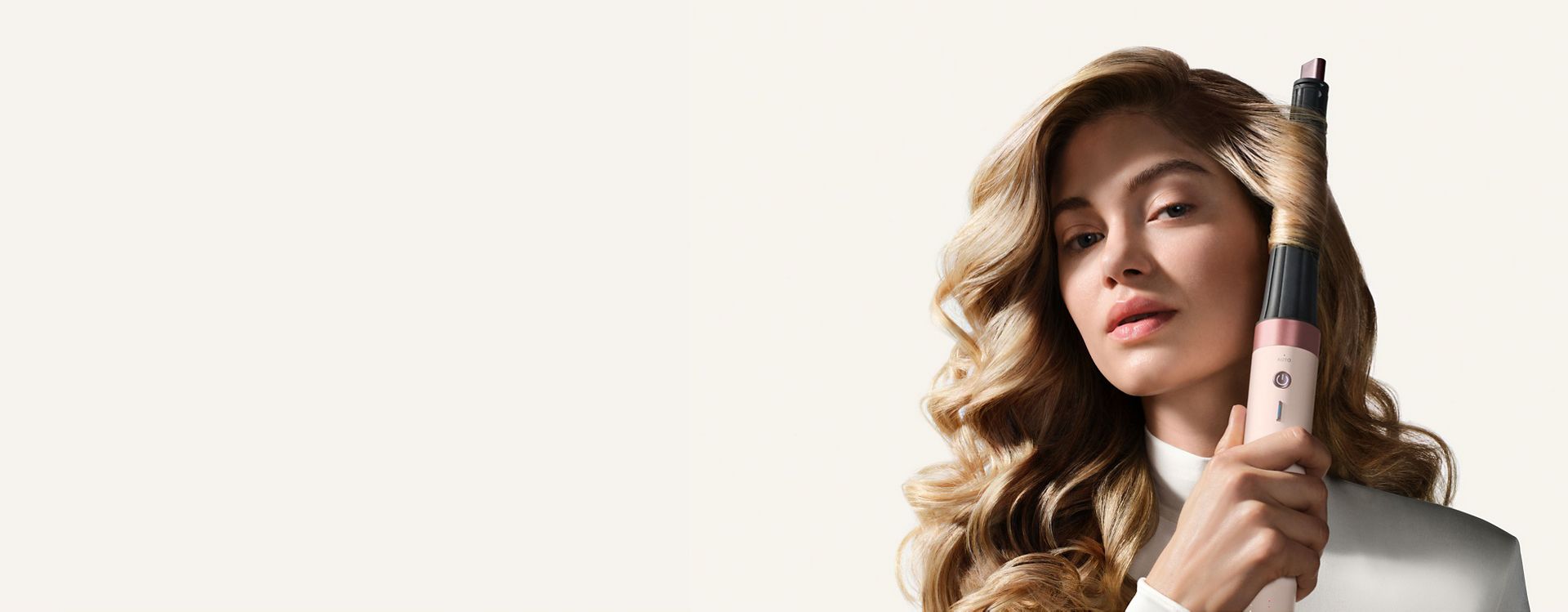 Model uses the Dyson Airwrap Conical Co-anda2x curling barrel to curl her hair.