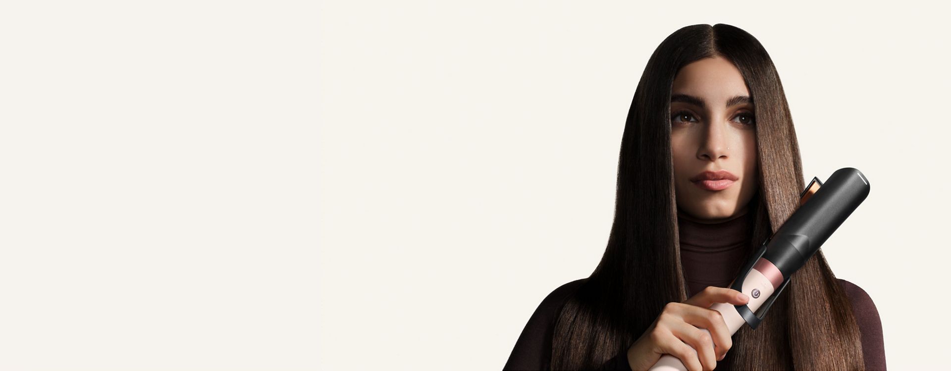 Model straightens her hair with the Dyson Air straightener 2x attachment.