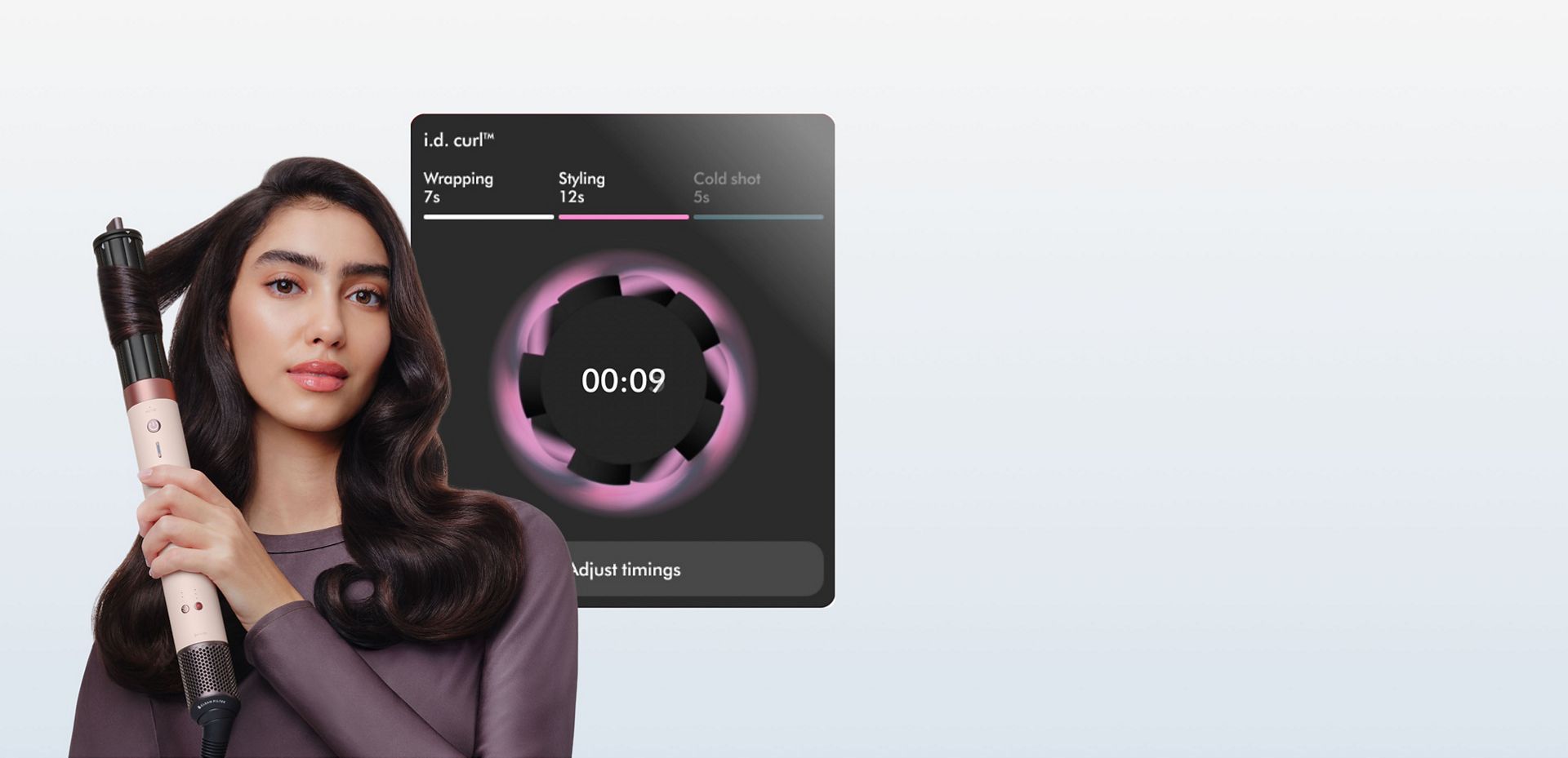 Model curls her hair in front of a screen showing the ID curl personalised curling sequence.