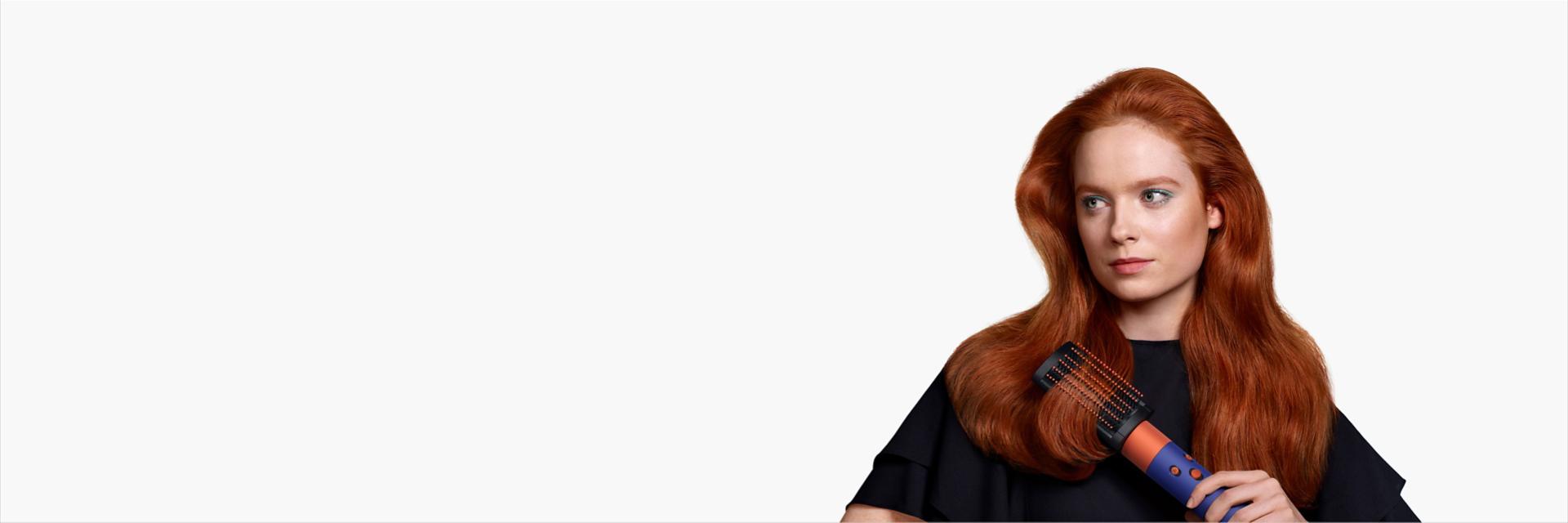 A model with long red hair uses the soft smoothing brush.