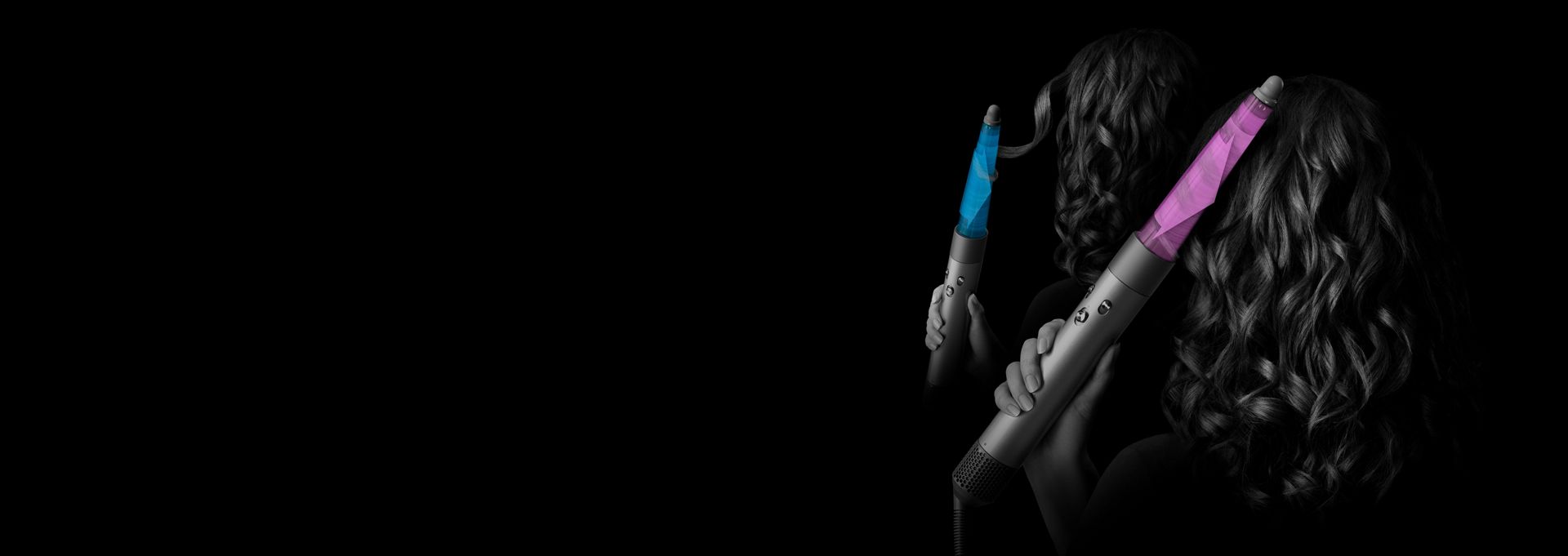 A model uses the Dyson Airwrap i.d. multi-styler and dryer to style their hair.