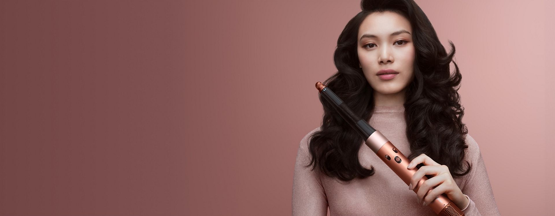 Dyson Airwrap ID multi-styler and dryer used by a model to curl her hair.