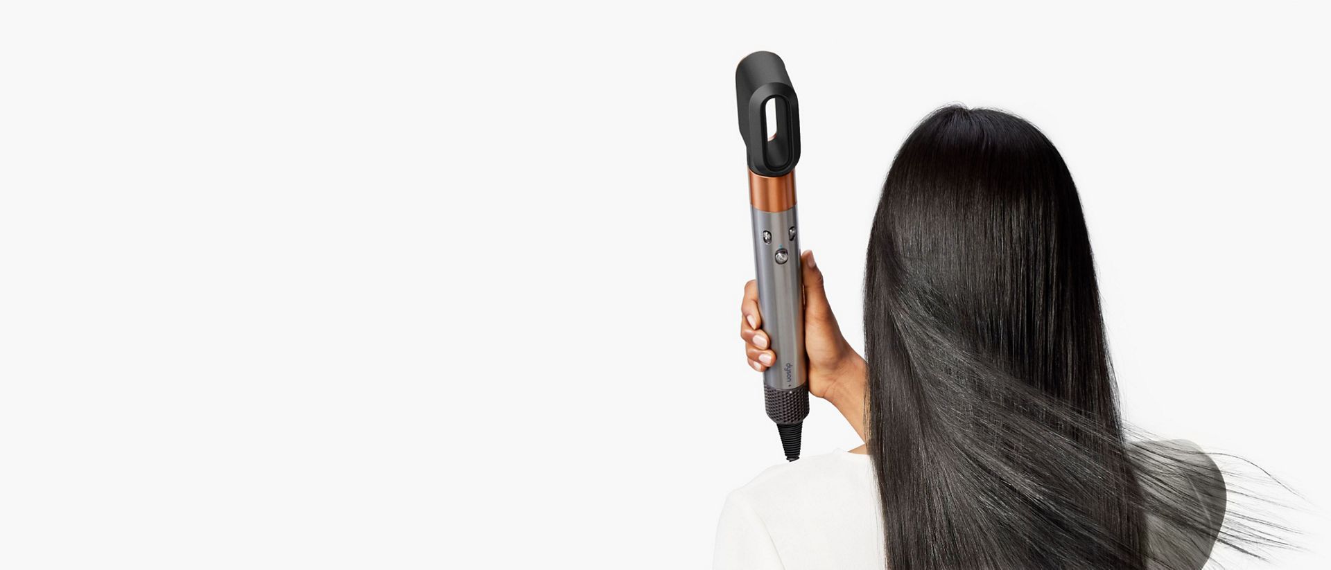 The Dyson Airwrap Origin multi-styler and dryer used by a model to dry her hair.