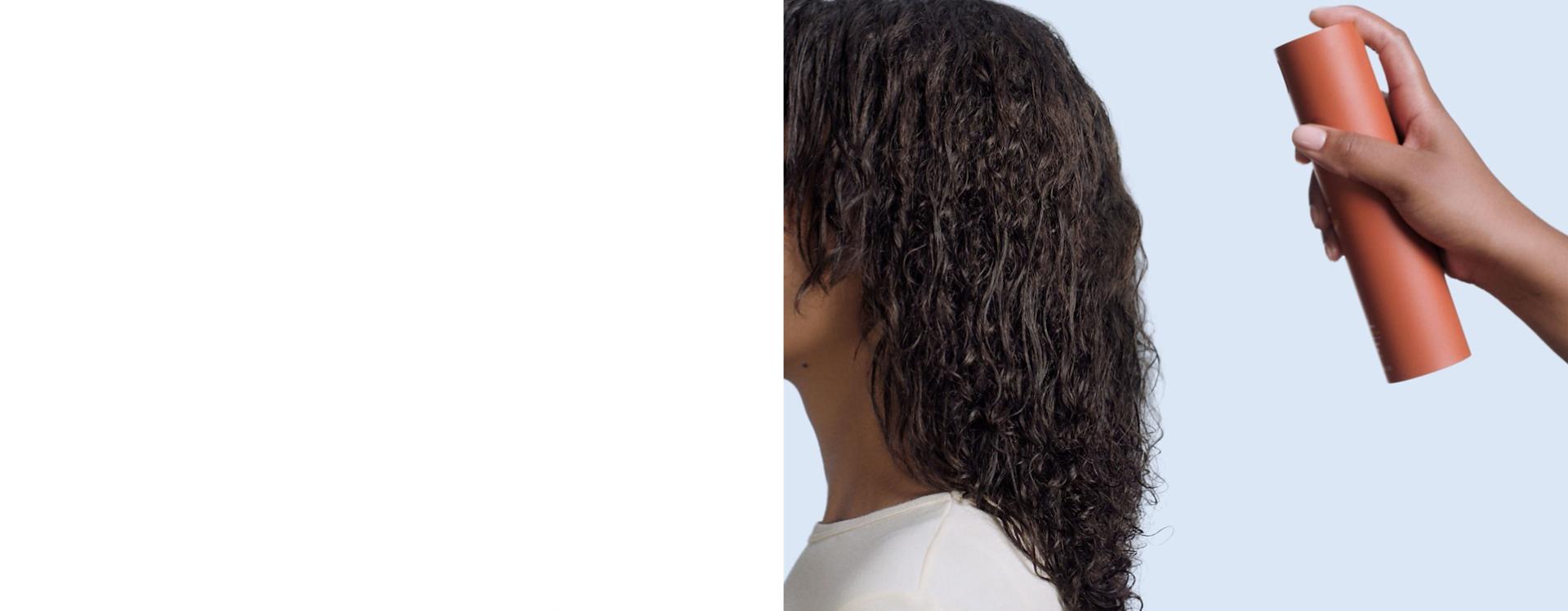 Dyson Omega leave-in conditioning spray is applied to hair.