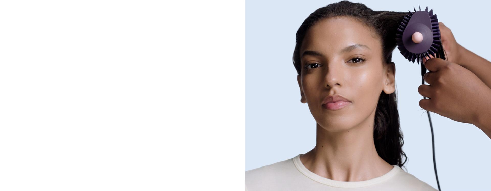 Dyson Airsmooth styling brush used to style hair.
