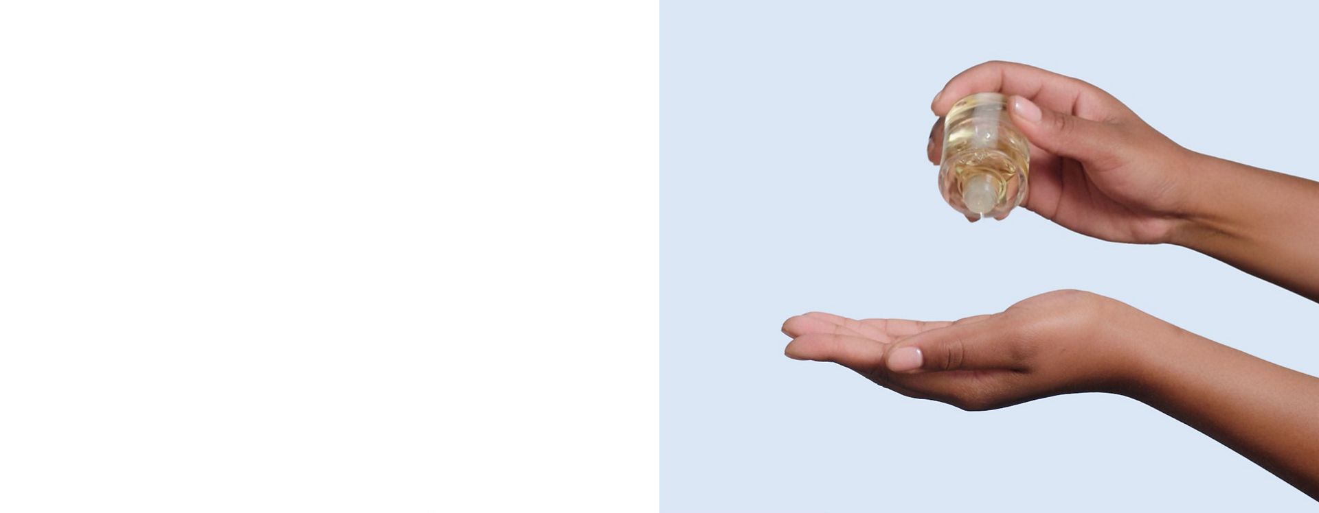 Dyson Omega hydrating hair oil is dispensed into the palm of a hand.