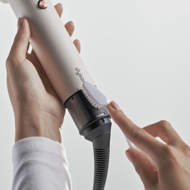The filter of the Dyson Airsmooth styling brush is cleaned with a soft-bristled toothbrush.