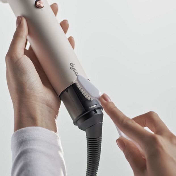 The filter of the Dyson Airsmooth styling brush is cleaned with a soft-bristled toothbrush.