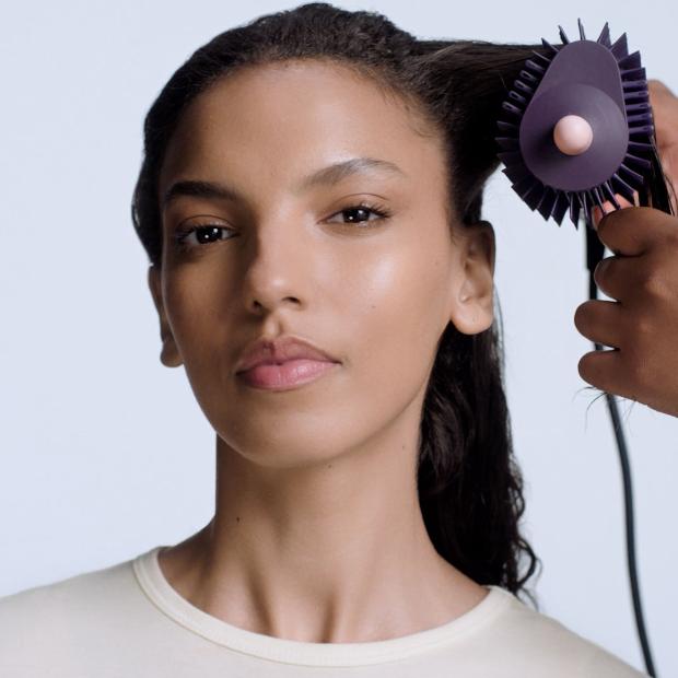 Dyson Airsmooth styling brush used to style a model's hair.