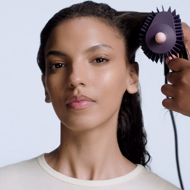 Dyson Airsmooth styling brush used to style a model's hair.