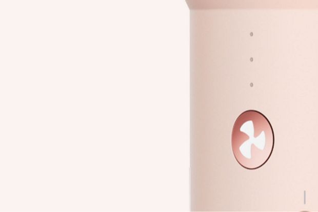 The airflow control button on the Dyson Airsmooth styling brush.