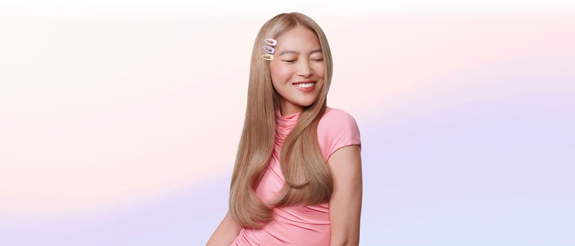 Model shows off styled hair achieved with the Dyson Airsmooth styling brush.