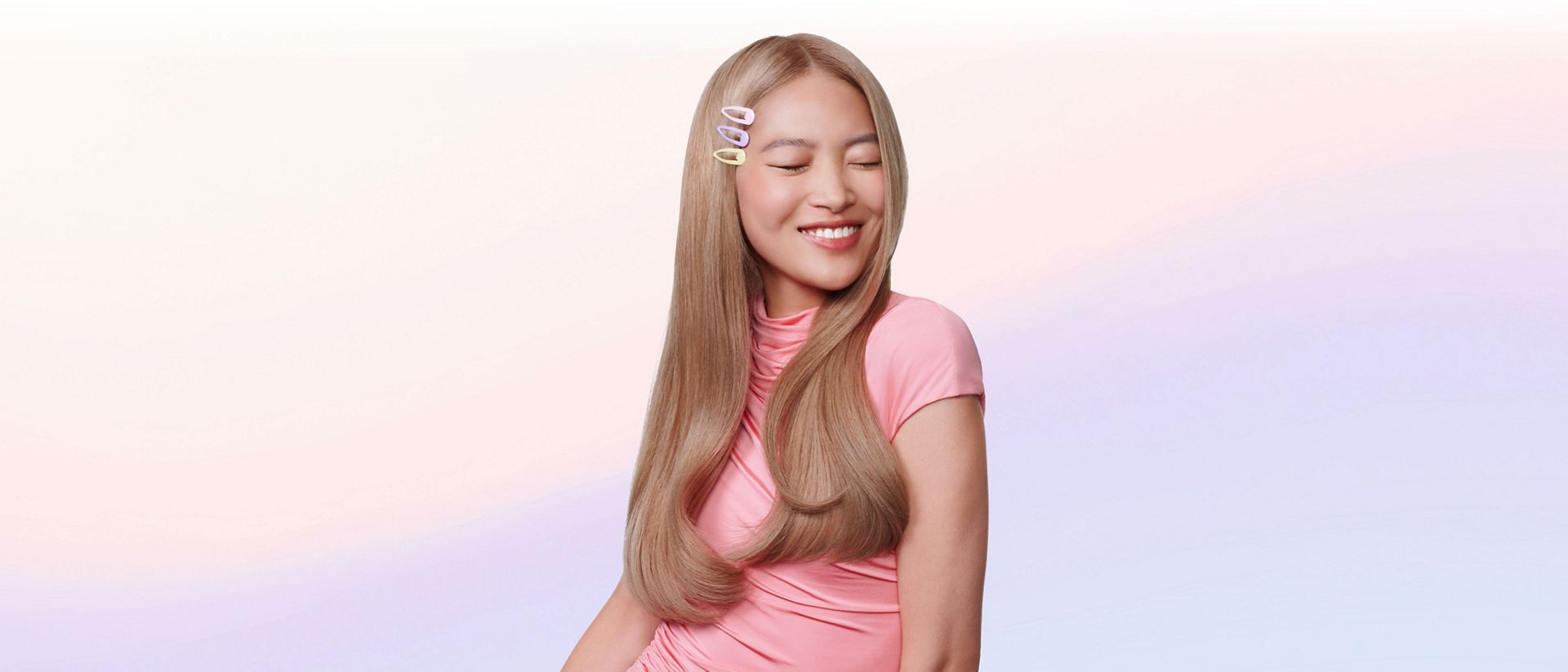 Model shows off styled hair achieved with the Dyson Airsmooth styling brush.
