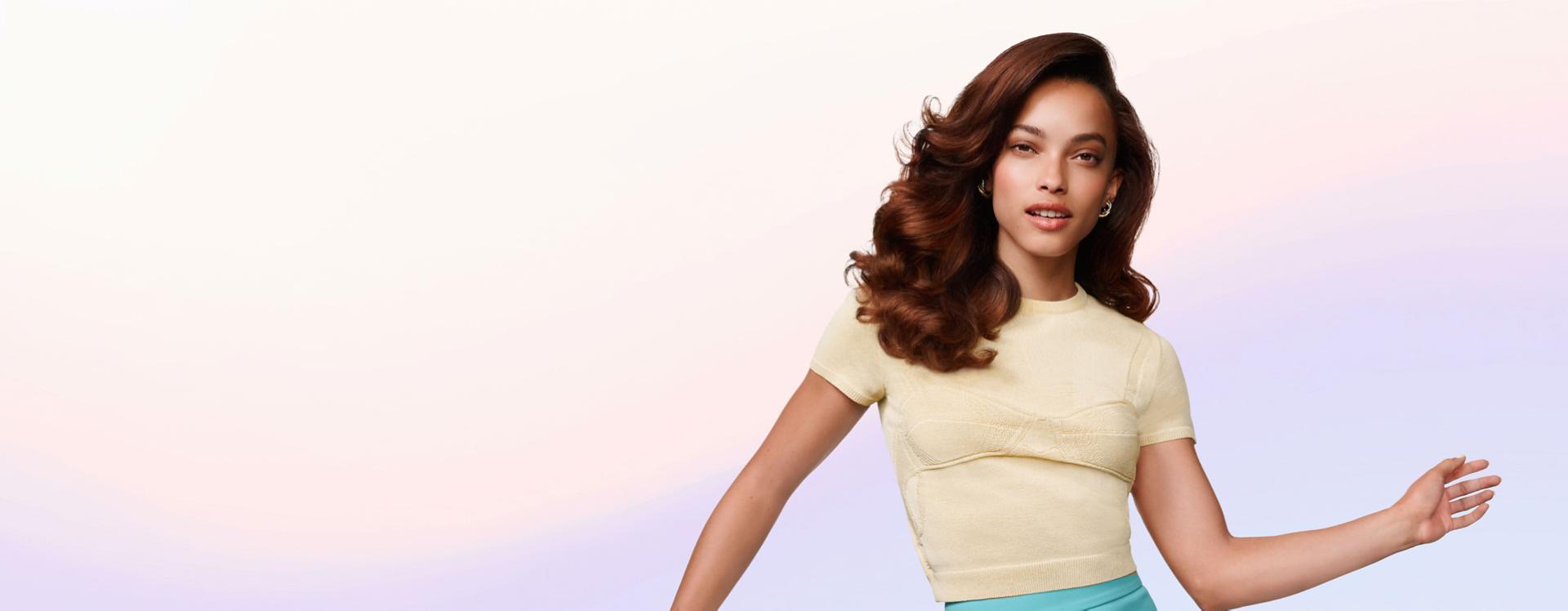 Model shows off styled hair achieved with the Dyson Airsmooth styling brush.