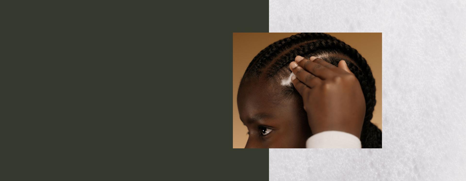 A model massages Dyson Amino leave-in scalp bubble treatment into her scalp.