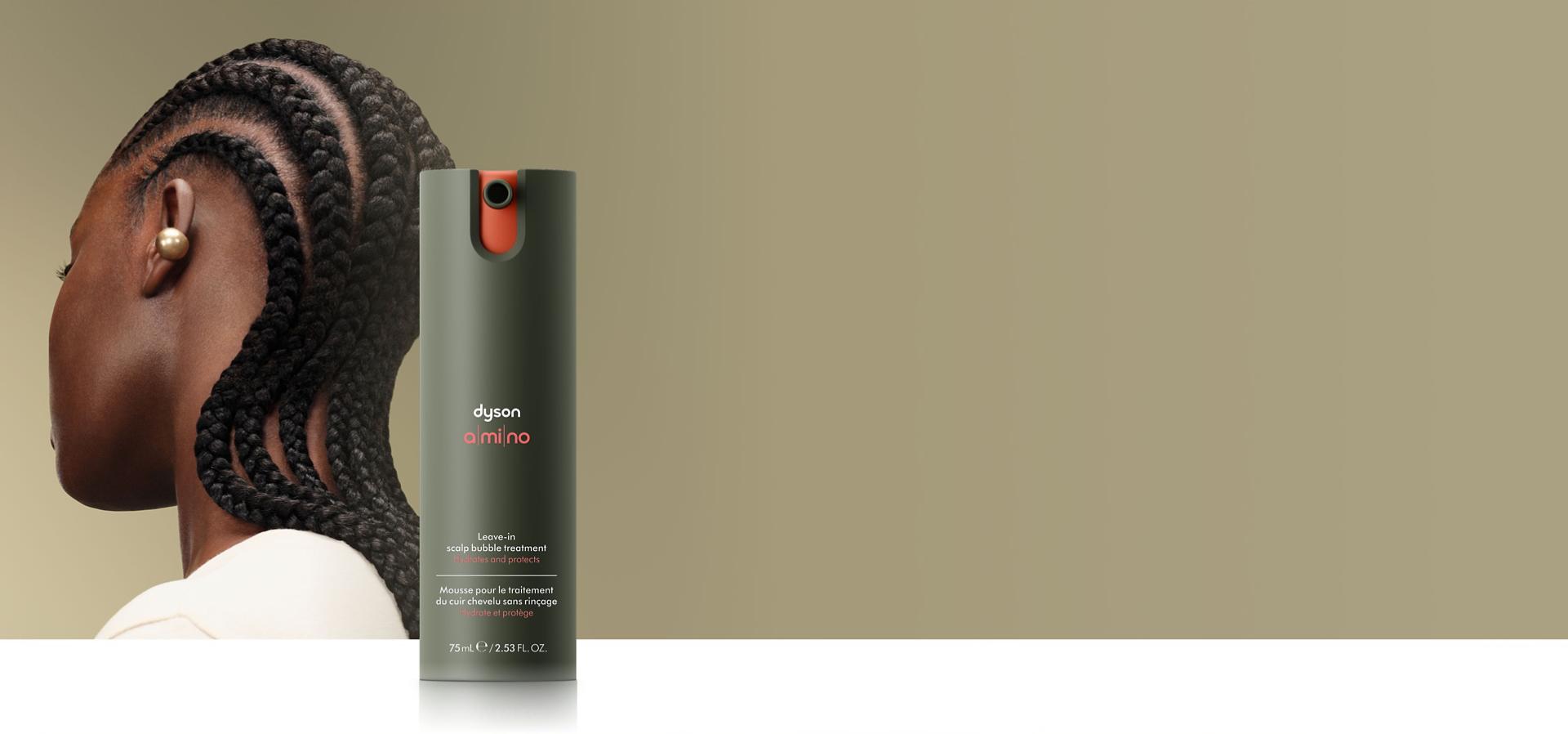 Dyson Amino leave-in scalp bubble treatment in front of a model.