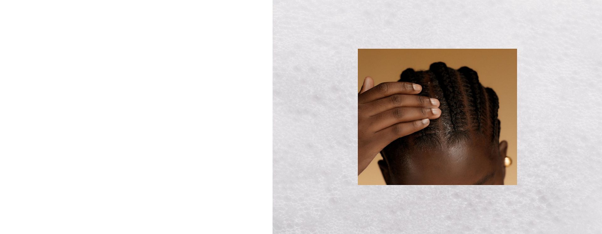 A model massages Dyson Amino leave-in scalp bubble treatment into their scalp.