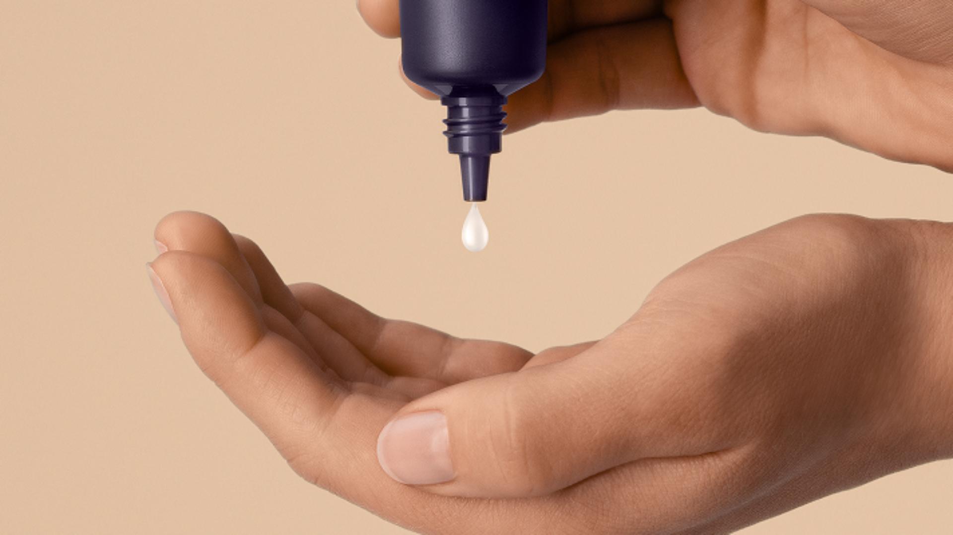 Dyson Chitosan Post-style serum squeezed into the hand.