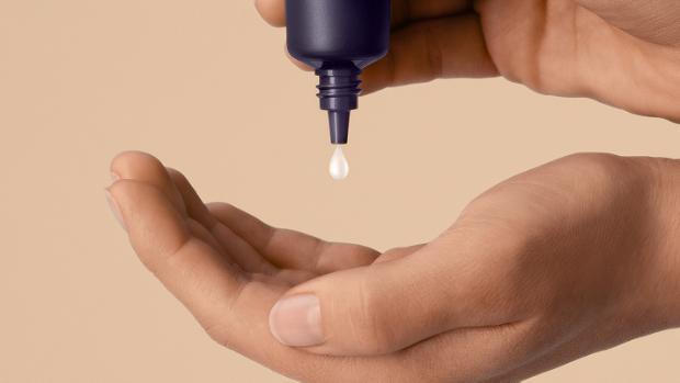 Dyson Chitosan Post-style serum squeezed into the hand.