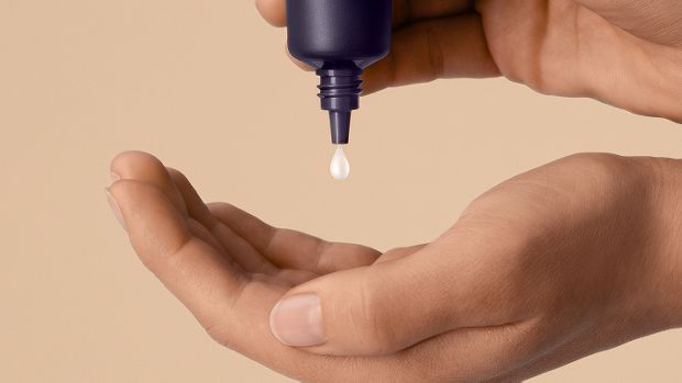 Dyson Chitosan Post-style serum squeezed into the hand.