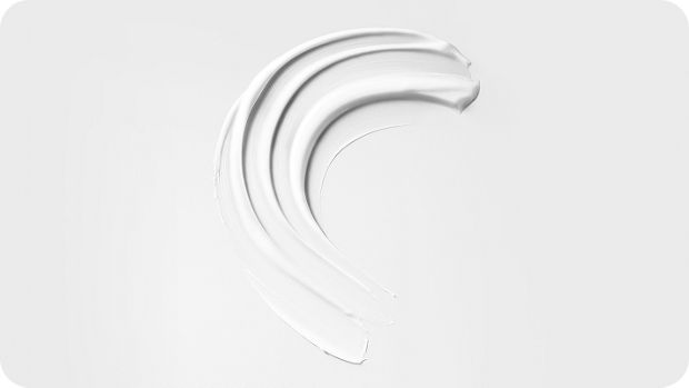 A swipe of pre-style cream on white background, showing texture.