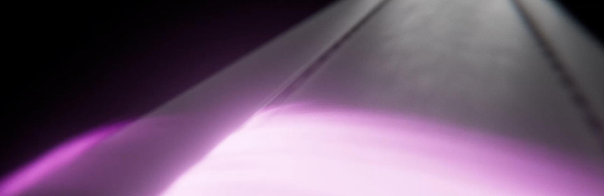 Pink graphics show the Coanda airflow over a Dyson Airwrap curling barrel.