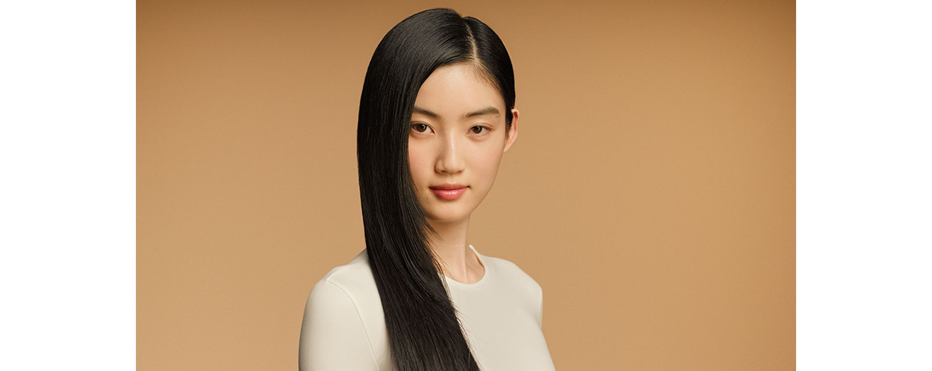 A model with sleek, straight, dark hair nourished with the Dyson Omega range.