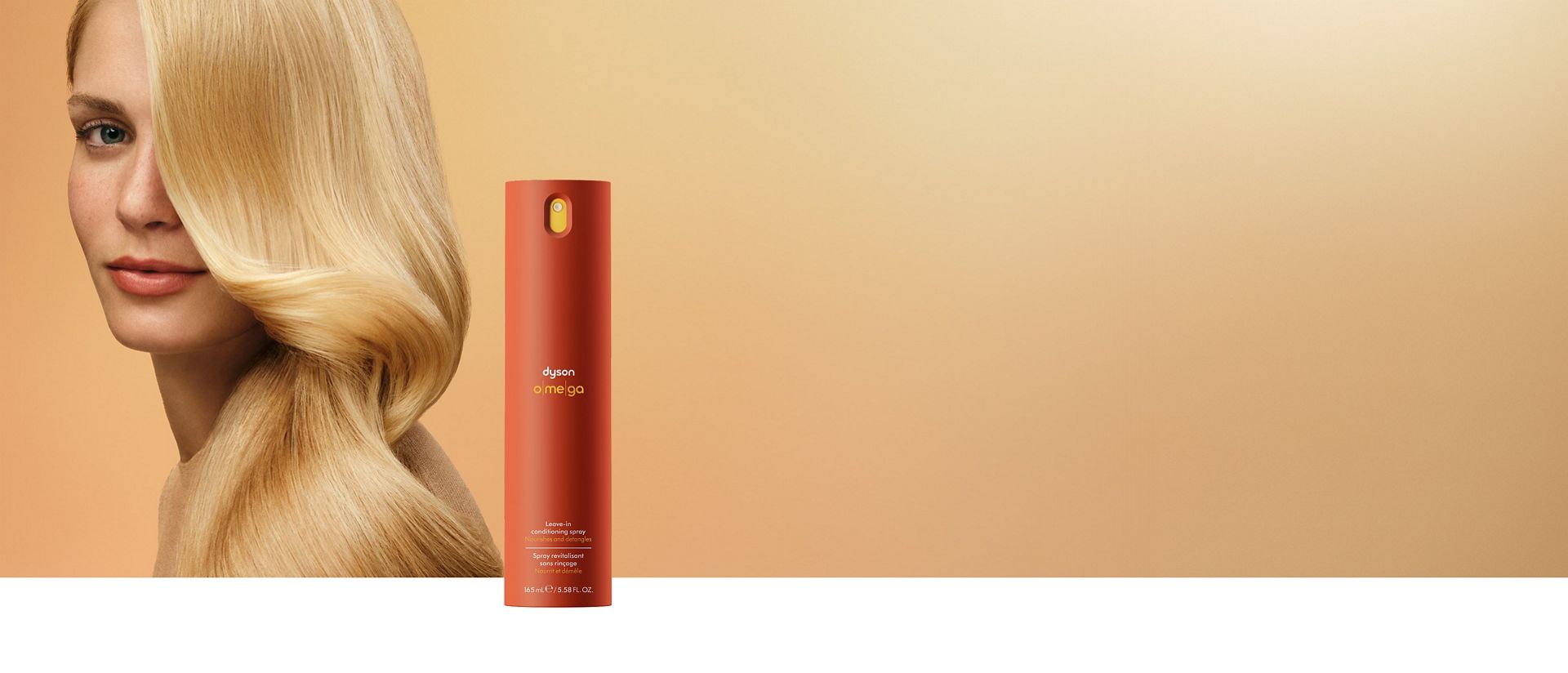 A blonde model behind the Dyson Omega leave-in conditioning spray.