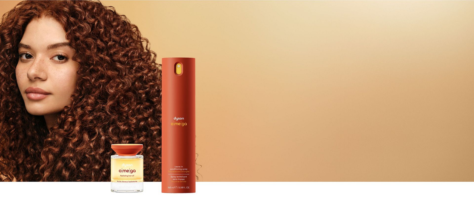 A curly haired model behind the Dyson Omega nourishing range.