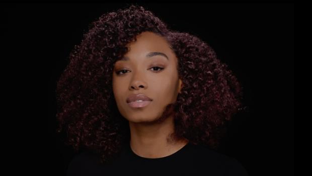 A model with styled hair set with Dyson Chitosan Multi-use styling spray.