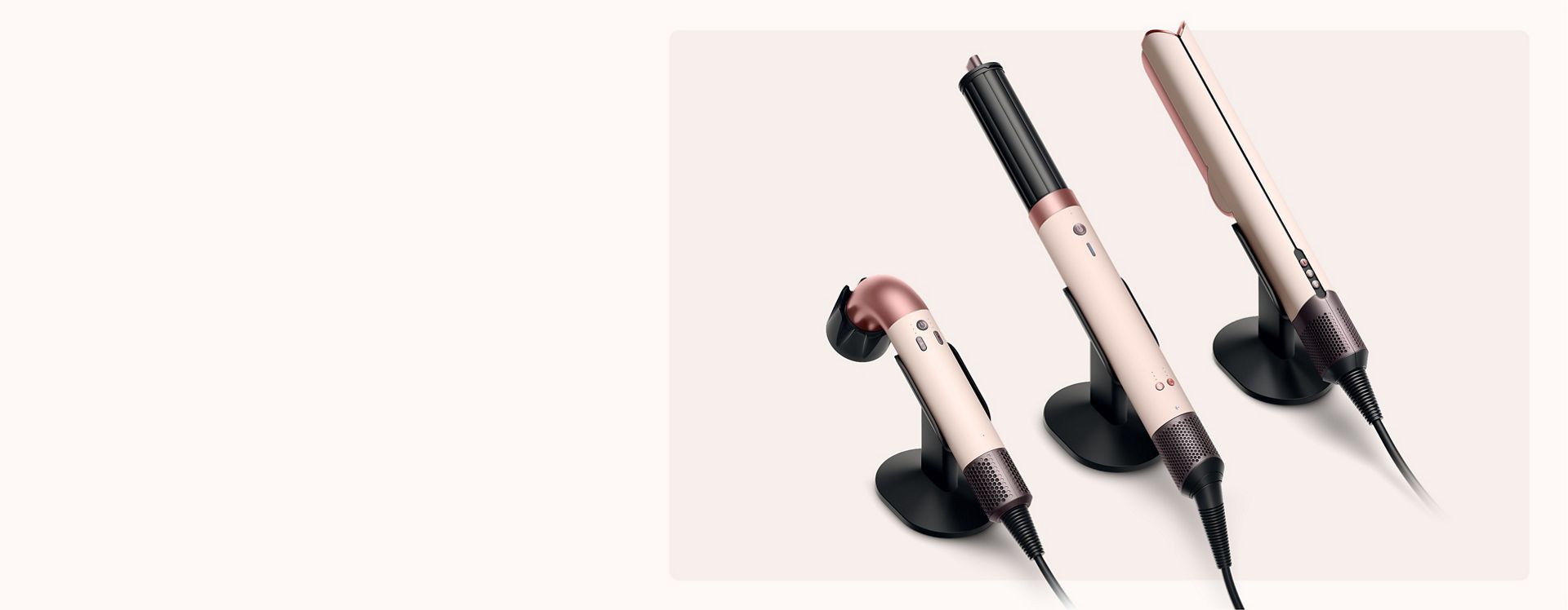 A range of Dyson hair care devices on the Dyson-designed display stand.
