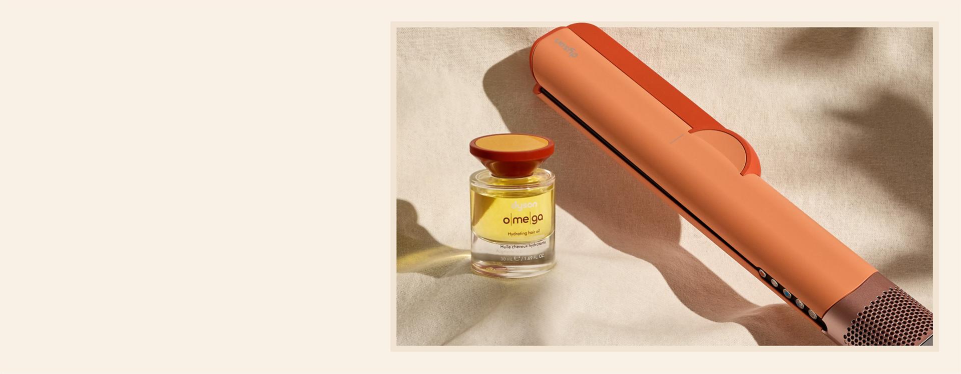 Dyson Airstrait dryer and straightener with Dyson Omega hydrating hair oil.