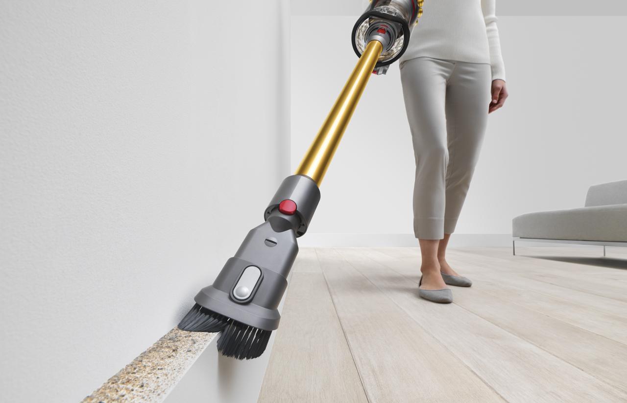 Woman using the Dyson Outsize Absolute vacuum as a handheld cleaner