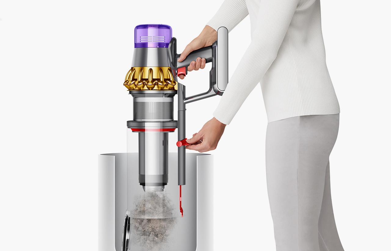 Woman emptying Dyson Outsize Absolute vacuum into bin