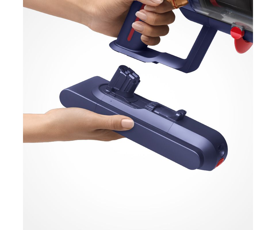 Dyson swappable battery clicking into the machine handle.