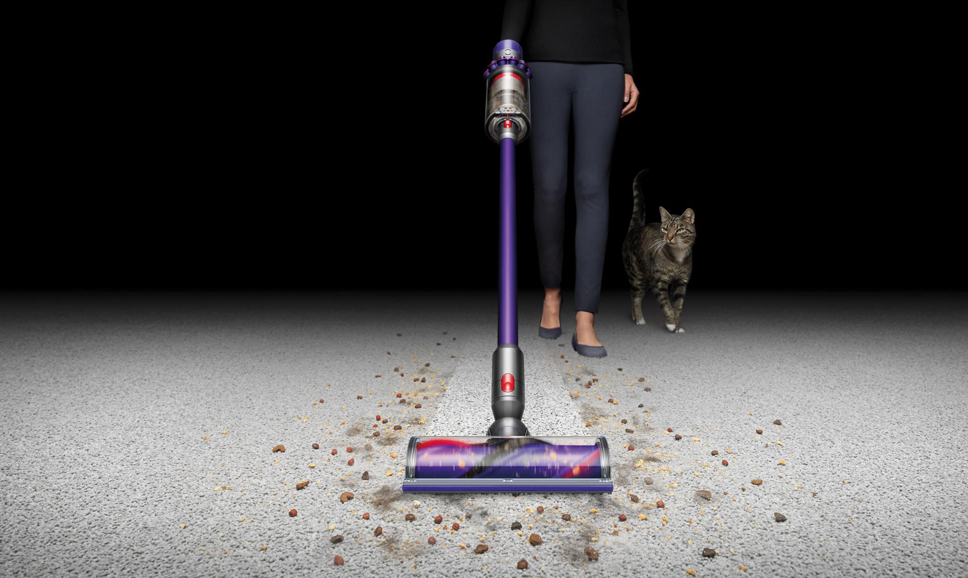 Dyson cordless pet vacuum being used to clean a hard floor, surfaces and up high