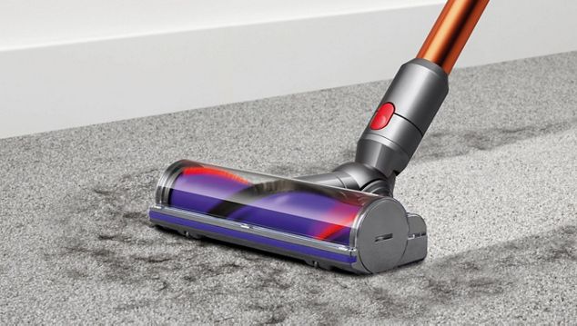 Dyson Cyclone V10™ vacuum in handheld mode cleaning car seat Dyson Cyclone V10™ vacuum in handheld mode cleaning car seat