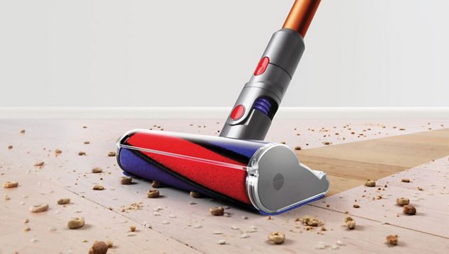 Dyson Cyclone V10™ vacuum in handheld mode cleaning car seat Dyson Cyclone V10™ vacuum in handheld mode cleaning car seat
